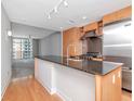 Modern kitchen with sleek wooden cabinets, stainless steel appliances, and a large granite island at 1120 E Kennedy Blvd # 1523, Tampa, FL 33602