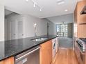 Open kitchen featuring a spacious island, stainless steel appliances, and views of the living space at 1120 E Kennedy Blvd # 1523, Tampa, FL 33602