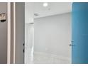 Bright entryway featuring neutral walls, tiled floor, and a pop of color from the blue door at 1208 E Kennedy Blvd # 1115, Tampa, FL 33602
