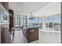 Modern kitchen with stainless steel appliances, island with breakfast bar, and stunning cityscape views at 1208 E Kennedy Blvd # 1115, Tampa, FL 33602