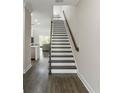 Bright foyer view of staircase with wood handrail, leading to an open concept living area at 12326 Terracina Chase Ct, Tampa, FL 33625