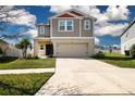 Two-story home with attached two-car garage, landscaped yard, and neutral color palette at 13106 Zolo Springs Cir, Riverview, FL 33579