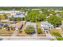 Aerial view of a neighborhood showcasing a one-story home with mature trees and lush surroundings at 13216 Parkhurst Ct, Riverview, FL 33569