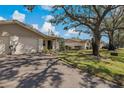 Charming single-story home featuring a well-manicured lawn, attached garage, and mature shade tree in a lovely neighborhood at 1541 Heather Ridge Blvd # 1541, Dunedin, FL 34698