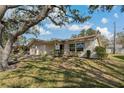 Charming single-story home featuring a well-manicured lawn, attached garage, and mature shade tree in a lovely neighborhood at 1541 Heather Ridge Blvd # 1541, Dunedin, FL 34698