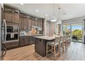 Modern kitchen with a large center island, barstool seating, stainless steel appliances, and stylish cabinetry at 18 Franklin S Ct # D, St Petersburg, FL 33711