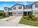 This two-story townhome features blue shutters, a driveway and tidy front yard at 9716 Mulberry Marsh Ln, Sun City Center, FL 33573