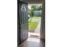 Inviting front entrance with black door, sidelight, and view of the landscaped front yard at 2301 46Th S St, St Petersburg, FL 33711