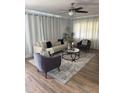Bright living room featuring hardwood floors, neutral colors, and stylish furnishings with a ceiling fan at 2301 46Th S St, St Petersburg, FL 33711