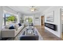 Bright living room with large windows, hardwood floors, fireplace, and neutral decor for a comfortable atmosphere at 2301 46Th S St, St Petersburg, FL 33711