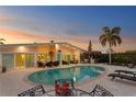 Backyard oasis with a large private pool, patio furniture, and a tiki bar, perfect for outdoor entertaining at 3943 Fontainebleau Dr, Tampa, FL 33634
