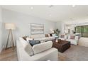 Open-concept living room with a large sectional, accent chairs, and a view into the kitchen at 532 W Plaza Pl # 2, Tampa, FL 33602