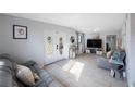 Bright living room with tile floors, stylish decor, and a comfortable seating arrangement, perfect for relaxation at 9169 Robin Rd, Seminole, FL 33777