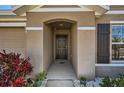 Inviting entryway with neutral colors and tasteful landscaping creates a warm welcome for residents and guests at 1274 Ocean Spray Dr, Ruskin, FL 33570