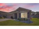 Charming single-story home boasts a well-maintained lawn, neutral-colored facade, and an attached two-car garage at 1274 Ocean Spray Dr, Ruskin, FL 33570