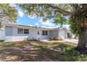 Inviting single-story home with a nicely shaded front yard and freshly painted exterior at 1350 Brixton Ln, Holiday, FL 34691