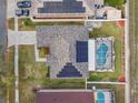 Aerial view of home with pool, solar panels, and fenced yard in a residential neighborhood at 1721 Loriana St, Brandon, FL 33511