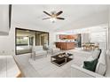 Open-concept living area with kitchen, dining area, and sliding glass door to lanai at 1740 Shady Leaf Dr, Valrico, FL 33596