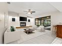 Bright living room with fireplace, ceiling fan and sliding glass doors to the lanai at 1740 Shady Leaf Dr, Valrico, FL 33596