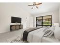 Spacious main bedroom featuring a sliding glass door leading to the screened-in lanai at 1740 Shady Leaf Dr, Valrico, FL 33596