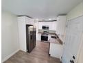Updated kitchen features stainless steel appliances, granite countertops, and white cabinetry at 2432 Auburn S St, St Petersburg, FL 33712