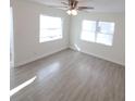 Bright living room featuring new wood-look tile flooring, ceiling fan, and lots of natural light at 2432 Auburn S St, St Petersburg, FL 33712