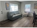 Living room featuring a leather couch, artwork, hardwood flooring, and bright natural light at 4221 5Th S Ave, St Petersburg, FL 33713