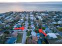 An aerial view of a neighborhood showcasing its proximity to the water with tree-lined streets at 4819 W Bay Villa Ave, Tampa, FL 33611