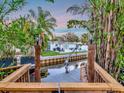 Scenic waterfront view with dock and lift, providing direct access to the open water and stunning sunsets at 4819 W Bay Villa Ave, Tampa, FL 33611