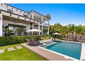 Beautiful backyard showcasing a luxurious pool, spa, lounge chairs, and manicured greenery at 5004 S The Riviera, Tampa, FL 33609