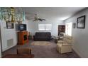 Bright living room with a ceiling fan, fireplace, and comfortable seating arrangement at 5925 Terrace Park N Dr # 111, St Petersburg, FL 33709