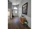 Inviting entryway with high ceilings, beautiful wood floors, and elegant wainscoting at 6601 Thackston Dr, Riverview, FL 33578