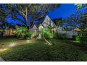 Inviting home exterior at night with landscape lighting and lush greenery at 156 21St Ne Ave, St Petersburg, FL 33704
