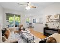 Sunlit living room with hardwood floors, comfortable seating, ceiling fan, and open layout at 1910 E Palm Ave # 10301, Tampa, FL 33605