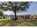 Charming single-story home featuring a two-car garage and a well-maintained front yard at 211 S Obrien St, Tampa, FL 33609