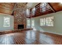 Spacious living room showcasing a floor-to-ceiling brick fireplace and bright natural light at 2901 Pelham Rd N, St Petersburg, FL 33710