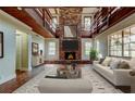 Inviting living room featuring a brick fireplace, wood accents, and an abundance of natural light at 2901 Pelham Rd N, St Petersburg, FL 33710