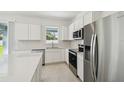 Bright kitchen boasts stainless appliances, white cabinets, and an open layout at 4227 Big Sky Dr, Spring Hill, FL 34604