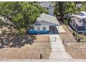 Quaint single-story home with a carport, fenced yard and a well-maintained lawn at 5511 N 32Nd St, Tampa, FL 33610