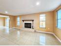 Cozy living room with large windows offering plenty of natural light and fireplace at 6718 Ranchwood Loop, New Port Richey, FL 34653