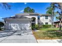 Spacious two-story home with a three-car garage and well-maintained lawn at 18126 Kara Ct, Tampa, FL 33647