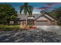 Charming brick home featuring a well-maintained yard, mature landscaping, and a spacious driveway at 1902 Sweet Bay Ct, Plant City, FL 33566