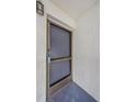 Exterior shot of a condo front door featuring a screen door, unit number, and secure locking mechanism at 256 Cypress Ln # 120, Oldsmar, FL 34677