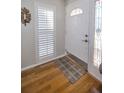 Inviting foyer features hardwood floors, plantation shutters, and decorative glass at 2731 Sherbrooke Ln # D, Palm Harbor, FL 34684