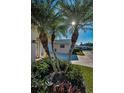 Landscaped yard featuring mature palm trees that accent the home's entrance at 2731 Sherbrooke Ln # D, Palm Harbor, FL 34684