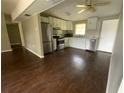 Open kitchen with stainless steel appliances and white cabinets at 3223 Coats Rd, Zephyrhills, FL 33541