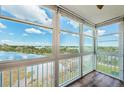 Enclosed sunroom with floor to ceiling windows providing panoramic waterfront views and natural light at 6315 Shoreline Dr # 3305, Madeira Beach, FL 33708