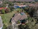 Gorgeous home with screened pool, well-manicured lawn, and mature trees at 9101 Highland Ridge Way, Tampa, FL 33647