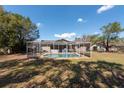 Inviting screened-in pool area with a sparkling blue pool and ample space for lounging and enjoying the outdoors at 11304 Sedgefield Ave, Spring Hill, FL 34608