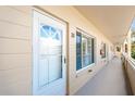 Exterior front door, white door with glass panes, and windows with blinds at 2041 Australia W Way # 35, Clearwater, FL 33763